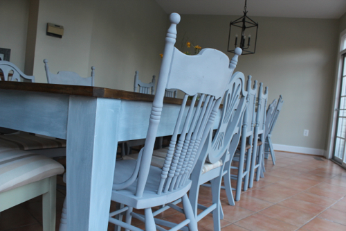 All different antique chairs painted in the same gray color.
